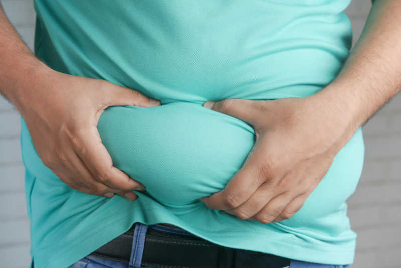 A person grabbing their belly - plenty of fuel on board